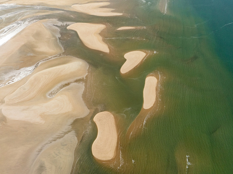 Aerial view of sandbars where the golden sands meet the tranquil turquoise waters creating a mesmerizing dance of light and shadow Abel Tasman Tasman Region New Zealand. Aerial view of sandbars where the golden sands meet the tranquil turquoise waters creating a mesmerizing dance of light and shadow Abel Tasman Tasman Region New Zealand.