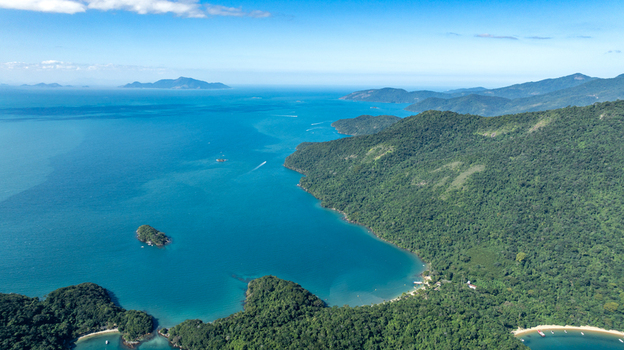 Aerial view of Lagoa Azul surrounded by lush green hills turquoise waters and small islands in Angra dos Reis Rio de Janeiro Brazil.