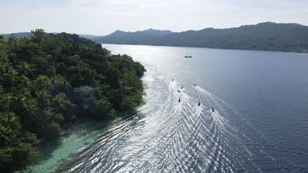 Aerial view of boats cruising near Raja Ampat Indonesia. Aerial view of boats cruising near Raja Ampat Indonesia.