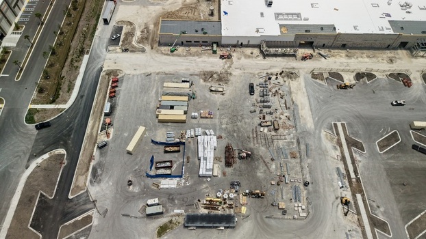 Aerial view of the construction site at Foundry Lane featuring shipping containers building materials and heavy machinery in World Golf Village Florida United States.