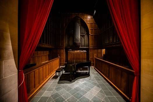 Washington District of Columbia United States 06 May 2025 View of a grand piano and pipe organ inside the Washington National Cathedral framed by red curtains.