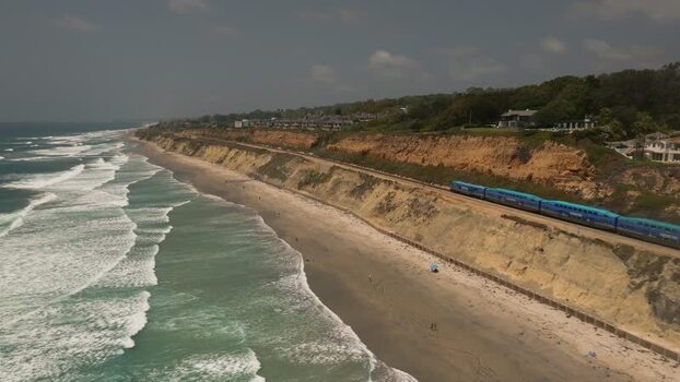 Aerial view of a train on coastal bluffs in San Diego United States.