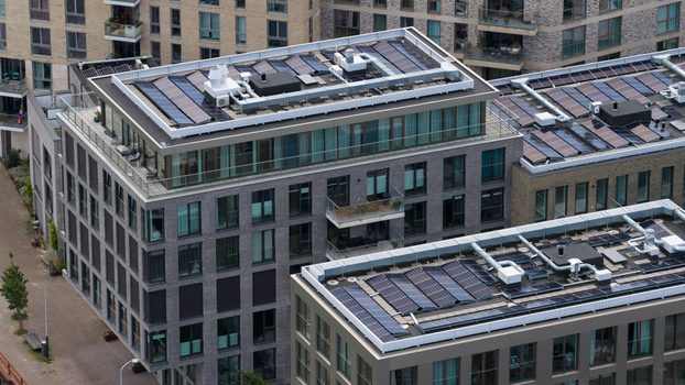 Aerial view of modern apartment buildings with solar panels on the rooftops at Cruquiusweg Amsterdam Noord Holland Netherlands.