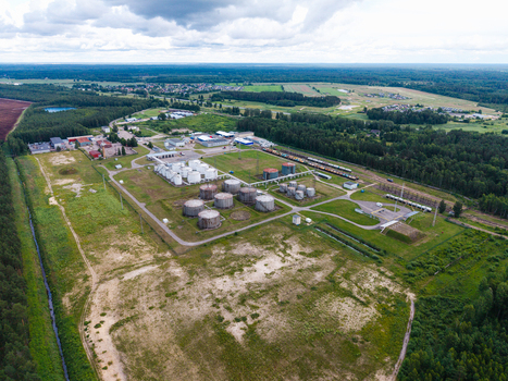 Olaine parish Latvia 04 July 2026 Aerial view of an industrial oil storage facility with large cylindrical tanks surrounding green fields and forested areas. Olaine parish Latvia 04 July 2026 Aerial view of an industrial oil storage facility with large cylindrical tanks surrounding green fields and forested areas.