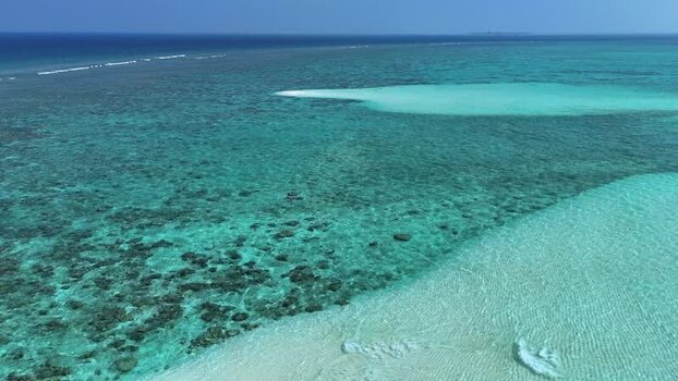 Aerial view of vibrant coral reefs and turquoise waters Maldives. Aerial view of vibrant coral reefs and turquoise waters Maldives.
