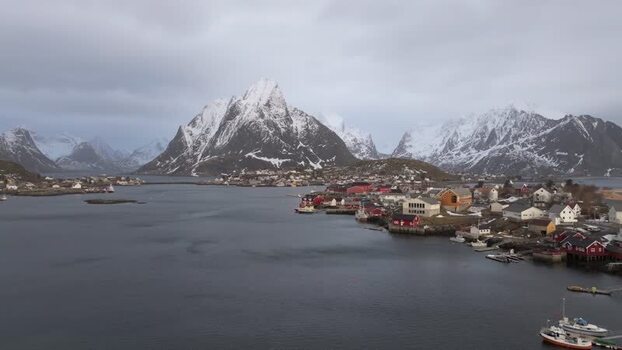 Aerial view of Lofoten village and snow capped mountains Norway.
