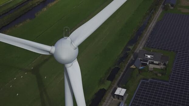 Aerial view of wind turbine and solar panels in the Netherlands.