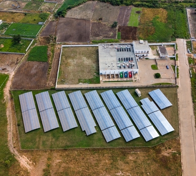 Aerial view of the Data Center in Katamanso featuring extensive solar panel arrays and a modern facility building surrounded by rural landscape in Ghana.
