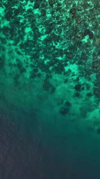 Aerial view of turquoise coral reef waters in Bali Indonesia.