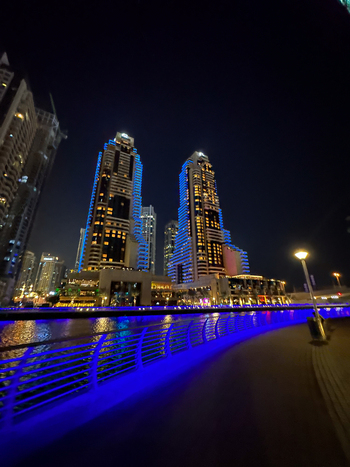 View of Grosvenor House a Luxury Collection Hotel Dubai illuminated at night along the marina promenade with blue lights Dubai Dubai United Arab Emirates. View of Grosvenor House a Luxury Collection Hotel Dubai illuminated at night along the marina promenade with blue lights Dubai Dubai United Arab Emirates.