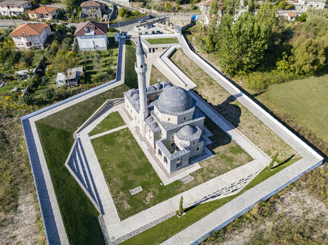 Aerial view of the historic Lead Mosque with its stone domes and minaret surrounded by manicured lawns and stone pathways in Shkoder Shkoder County Albania. Aerial view of the historic Lead Mosque with its stone domes and minaret surrounded by manicured lawns and stone pathways in Shkoder Shkoder County Albania.