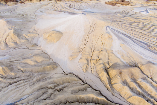 Aerial view of the Mud Volcanoes Paclele Mari showing unique cracked clay formations and geological patterns in the landscape of Paclele Buzau County Romania.