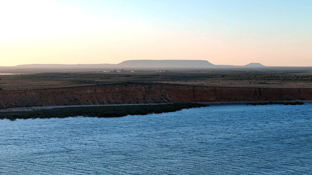 Aerial view of Matthew Flinders Red Cliff Lookout overlooking the Spencer Gulf with rugged red cliffs and distant hills under a soft sunset sky Port Augusta West South Australia Australia. Aerial view of Matthew Flinders Red Cliff Lookout overlooking the Spencer Gulf with rugged red cliffs and distant hills under a soft sunset sky Port Augusta West South Australia Australia.