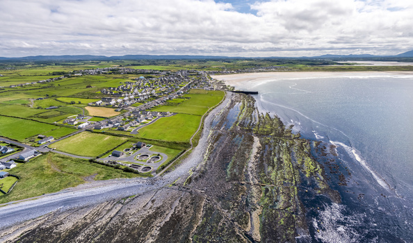 Aerial view of the water purification plant situated near the rocky coastline and green fields of the coastal town of Enniscrone County Sligo Ireland. Aerial view of the water purification plant situated near the rocky coastline and green fields of the coastal town of Enniscrone County Sligo Ireland.
