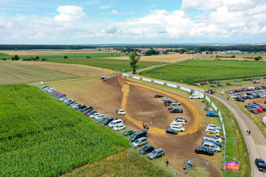 Herzogenaurach Germany 27 July 2025 Aerial view of Open Beatz Festival parking area and dirt track surrounded by lush green fields and rural landscape under a cloudy sky. Herzogenaurach Germany 27 July 2025 Aerial view of Open Beatz Festival parking area and dirt track surrounded by lush green fields and rural landscape under a cloudy sky.