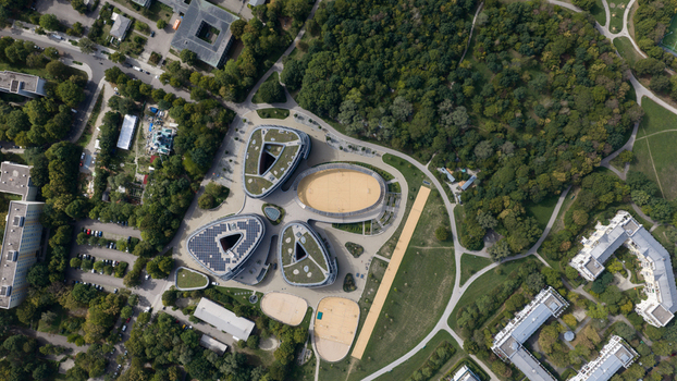 Durmersheim Germany 12 September 2026 Aerial view of the Wilhelm Hausenstein Gymnasium complex with modern organic shaped buildings green roofs sports fields and surrounding parkland.