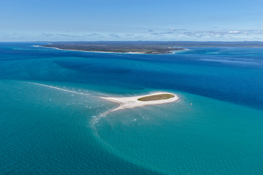 Aerial view of Pelican Bank a small sand island surrounded by turquoise waters and the coastline of K gari in the background K gari Queensland Australia. Aerial view of Pelican Bank a small sand island surrounded by turquoise waters and the coastline of K gari in the background K gari Queensland Australia.