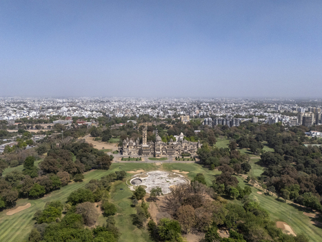 Vadodara India 14 March 2026 Aerial view of Laxmi Vilas Palace surrounded by lush green gardens and a golf course under a clear blue sky. Vadodara India 14 March 2026 Aerial view of Laxmi Vilas Palace surrounded by lush green gardens and a golf course under a clear blue sky.
