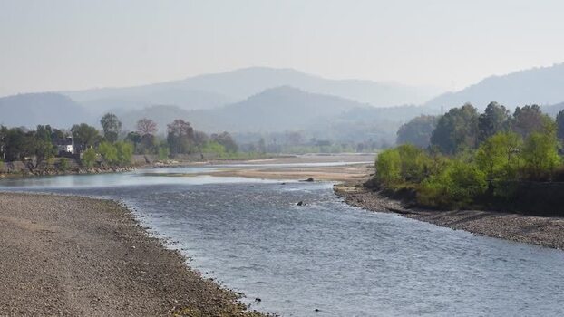 View of a wide river flowing through a valley Nepal.