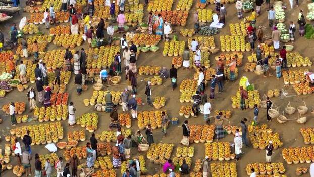 Aerial view of a crowded fruit market with produce baskets Bangladesh.