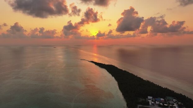 Aerial view of a tropical island at sunset over the ocean Maldives. Aerial view of a tropical island at sunset over the ocean Maldives.
