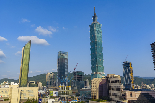 Aerial view of Taipei 101 skyscraper rising above the modern urban skyline of Taipei Taiwan. Aerial view of Taipei 101 skyscraper rising above the modern urban skyline of Taipei Taiwan.