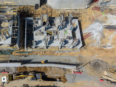 Aerial view of a construction site with concrete foundations steel reinforcement bars heavy machinery and an excavator in Istanbul Istanbul Turkiye.