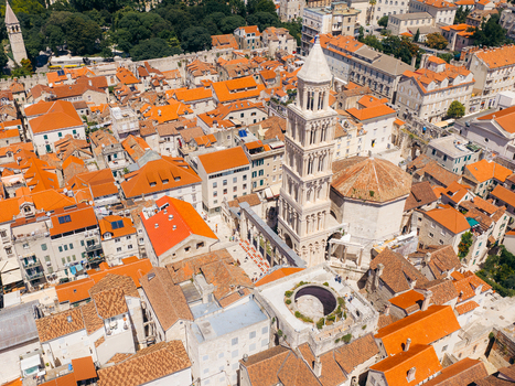 Aerial view of the Cathedral of Saint Domnius and the historic orange rooftops of Diocletian s Palace under a bright sun in Split Split Dalmatia County Croatia. Aerial view of the Cathedral of Saint Domnius and the historic orange rooftops of Diocletian s Palace under a bright sun in Split Split Dalmatia County Croatia.
