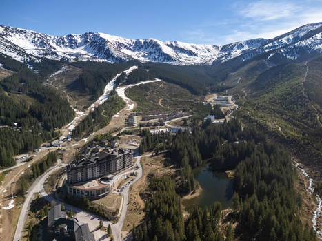 Aerial view of DAMIAN JASNA Hotel Resort and Residences nestled in a lush valley with pine forests and snow capped mountains Demanovska Dolina Zilinsky kraj Slovakia. Aerial view of DAMIAN JASNA Hotel Resort and Residences nestled in a lush valley with pine forests and snow capped mountains Demanovska Dolina Zilinsky kraj Slovakia.