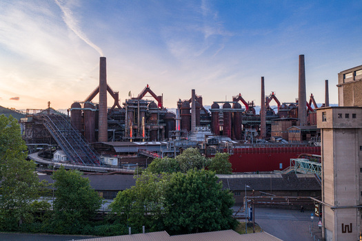 Volklingen Germany 09 May 2026 Aerial view of the Volklingen Ironworks industrial complex with its massive blast furnaces and chimneys under a soft sunset sky. Volklingen Germany 09 May 2026 Aerial view of the Volklingen Ironworks industrial complex with its massive blast furnaces and chimneys under a soft sunset sky.