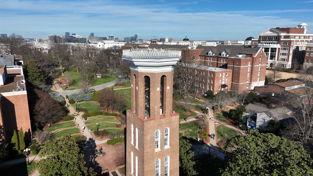 Aerial view of the historic brick bell tower at Vanderbilt University surrounded by lush campus grounds walkways and the distant city skyline in Nashville Tennessee United States. Aerial view of the historic brick bell tower at Vanderbilt University surrounded by lush campus grounds walkways and the distant city skyline in Nashville Tennessee United States.