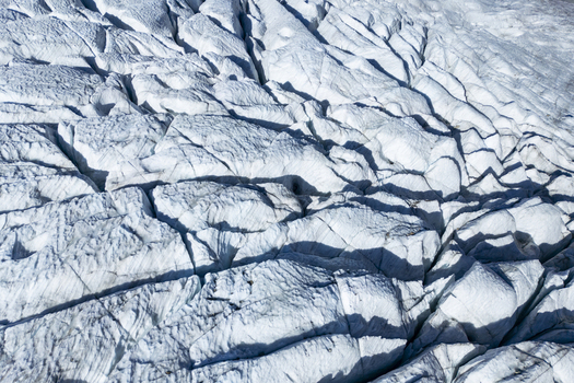 Aerial view of the fractured icy expanse of Morteratsch Glacier s rugged terrain a study in glacial textures Morteratsch Glacier Grisons Switzerland. Aerial view of the fractured icy expanse of Morteratsch Glacier s rugged terrain a study in glacial textures Morteratsch Glacier Grisons Switzerland.