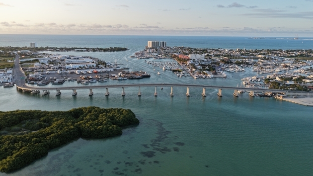Aerial view of the Yucalpeten bridge and harbor with boats docked in the marina and lush mangroves in the foreground in Progreso Yucatan Mexico. Aerial view of the Yucalpeten bridge and harbor with boats docked in the marina and lush mangroves in the foreground in Progreso Yucatan Mexico.