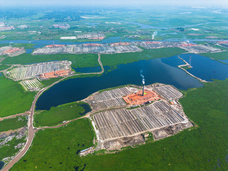 Aerial view of brick kilns casting shadows over the water a landscape of industry meeting nature Dhaka Dhaka Bangladesh. Aerial view of brick kilns casting shadows over the water a landscape of industry meeting nature Dhaka Dhaka Bangladesh.