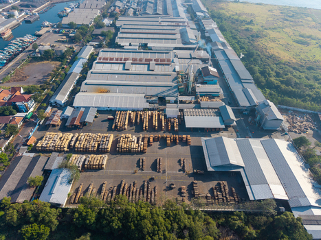 Probolinggo East Java Indonesia 06 August 2026 Aerial view of a large industrial timber processing facility with stacks of lumber metal roofed warehouses and a nearby harbor. Probolinggo East Java Indonesia 06 August 2026 Aerial view of a large industrial timber processing facility with stacks of lumber metal roofed warehouses and a nearby harbor.