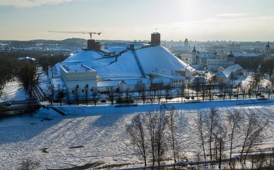 Aerial view of Gediminas Tower and the Upper Castle on a snow covered hill overlooking the frozen Neris River in Vilnius County Lithuania.