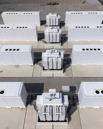 Aerial view of the Battery Energy Storage System at a wind park featuring rows of white industrial battery containers and electrical transformers on a concrete pad in Dronten Flevoland Netherlands. Aerial view of the Battery Energy Storage System at a wind park featuring rows of white industrial battery containers and electrical transformers on a concrete pad in Dronten Flevoland Netherlands.