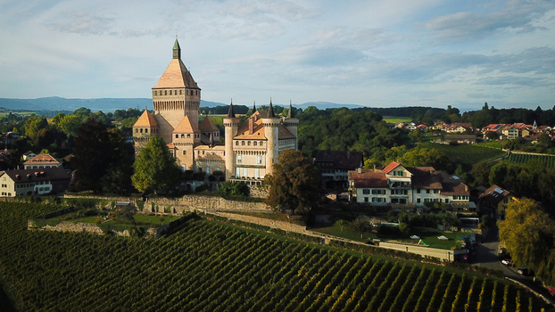 Aerial view of the medieval Vufflens le Chateau castle with its prominent central tower and surrounding vineyards in Vufflens le Chateau Vaud Switzerland. Aerial view of the medieval Vufflens le Chateau castle with its prominent central tower and surrounding vineyards in Vufflens le Chateau Vaud Switzerland.