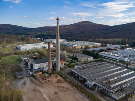 Aerial view of industrial buildings with tall chimneys piercing the skyline a landscape where urban meets nature s green embrace Detva Banskobystricky kraj Slovakia. Aerial view of industrial buildings with tall chimneys piercing the skyline a landscape where urban meets nature s green embrace Detva Banskobystricky kraj Slovakia.