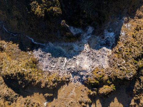 Aerial view of the rugged volcanic terrain of Gunung Sumbing Wonosobo with rocky slopes and sparse vegetation in Kecamatan Kalikajar Jawa Tengah Indonesia.