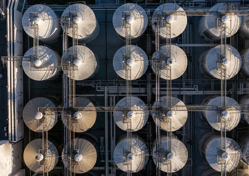 Aerial view of a beer industrial complex with large metal fermentation tanks and connecting pipes in Santo Domingo Dominican Republic. Aerial view of a beer industrial complex with large metal fermentation tanks and connecting pipes in Santo Domingo Dominican Republic.