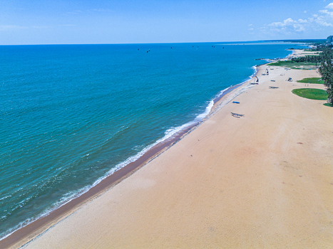 Aerial view of Negombo Beach with its golden sand turquoise ocean waves and traditional fishing boats resting on the shore in Negombo Western Province Sri Lanka. Aerial view of Negombo Beach with its golden sand turquoise ocean waves and traditional fishing boats resting on the shore in Negombo Western Province Sri Lanka.