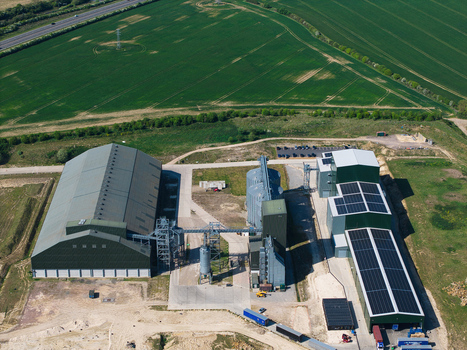 Aerial view of the Oat Milling Factory featuring large industrial warehouses storage silos and solar panel arrays surrounded by green agricultural fields Kettering England United Kingdom. Aerial view of the Oat Milling Factory featuring large industrial warehouses storage silos and solar panel arrays surrounded by green agricultural fields Kettering England United Kingdom.
