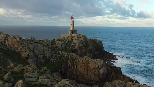 Aerial view of Faro de Punta Nariga on rocky cliffs Spain.