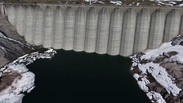 Aerial view of Lucendro Dam and snowy terrain in Airolo Switzerland. Aerial view of Lucendro Dam and snowy terrain in Airolo Switzerland.