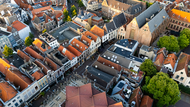Aerial view of the historic city center featuring traditional brick buildings with orange tiled roofs narrow streets and a large church in Zwolle Overijssel Netherlands.