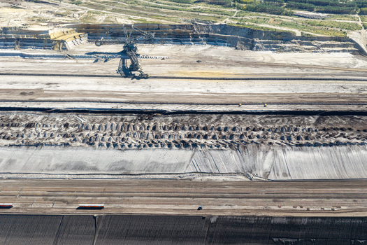 Aerial view of the Tagebau Welzow Sud brown coal open pit mine with a large bucket wheel excavator operating in the industrial landscape of Spremberg Brandenburg Germany. Aerial view of the Tagebau Welzow Sud brown coal open pit mine with a large bucket wheel excavator operating in the industrial landscape of Spremberg Brandenburg Germany.