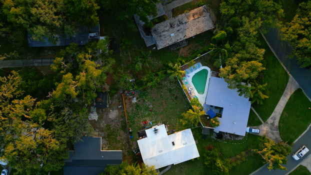 Aerial view of a residential neighborhood featuring houses with swimming pools lush green trees and suburban streets in Tampa Florida United States. Aerial view of a residential neighborhood featuring houses with swimming pools lush green trees and suburban streets in Tampa Florida United States.
