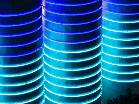 Aerial view of the BTB Heat and Power Plant Adlershof with glowing blue light rings visualizing real time heat energy stored inside industrial tanks in Berlin Berlin Germany. Aerial view of the BTB Heat and Power Plant Adlershof with glowing blue light rings visualizing real time heat energy stored inside industrial tanks in Berlin Berlin Germany.