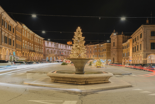 View of the illuminated Christmas tree and central fountain in the historic Piazza del Popolo at night in San Severino Marche Marche Italy. View of the illuminated Christmas tree and central fountain in the historic Piazza del Popolo at night in San Severino Marche Marche Italy.